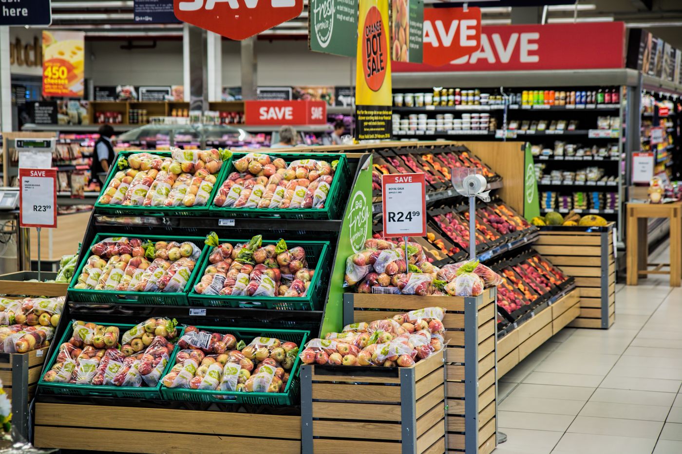 A market stall with baskets of fruit and vegetables